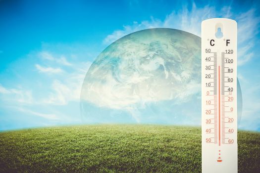 Thermometer check the earth's temperature with impact of global environment concept, Elements of this image furnished by NASA.