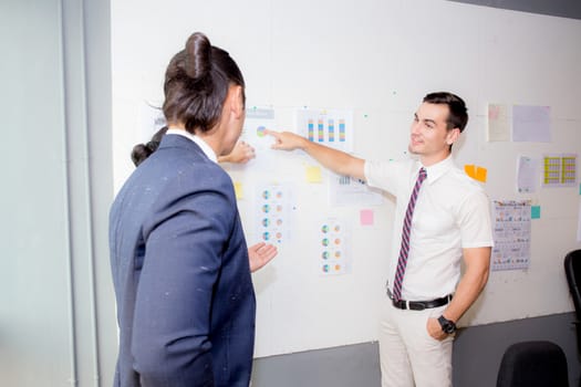 three business people in modern office looking report and analyzing with talking in meeting room.