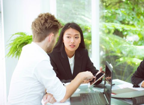 business man and woman people making meeting and looking at tablet for analyzing marketing working at office on desk.