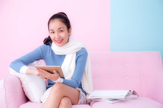 portrait of beautiful young woman relax on couch with tablet communication concept.