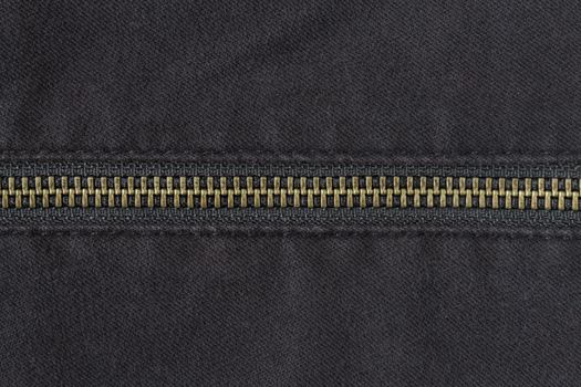 Brass Zip on Black Jeans Texture Background. Closed Brass Zip on Black Jeans Texture Background for Apparel Design