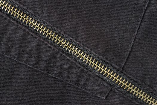 Brass Zip on Black Jeans Texture Background. Closed Brass Zip on Black Jeans Texture Background for Apparel Design