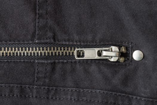 Closed Brass Zip on Black Jeans Texture Background. Closed Brass Zip on Black Jeans Texture Background for Apparel Design