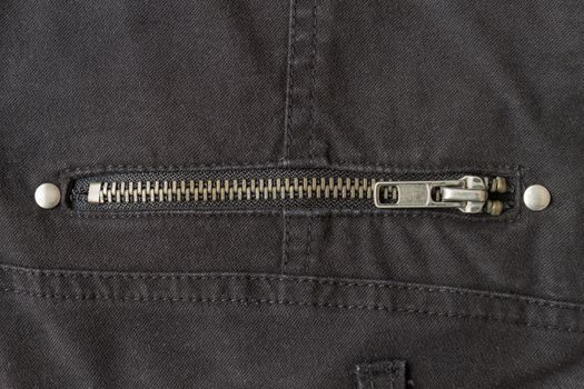 Closed Brass Zip on Black Jeans Texture Background. Closed Brass Zip on Black Jeans Texture Background for Apparel Design