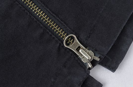 End of Closed Brass Zip on Black Jeans Texture Background. Closed Brass Zip on Black Jeans Texture Background for Apparel Design