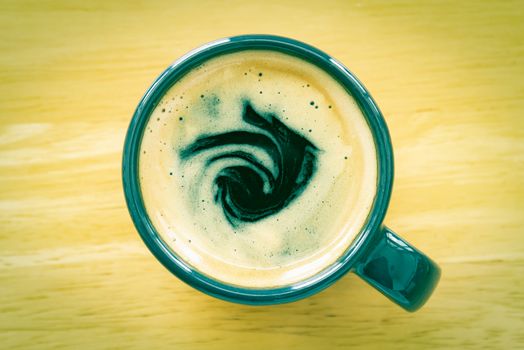 Espresso Coffee and Crema in Cup on Wood Table with Natural Light in Vintage Tone