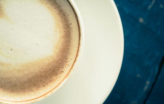 Vintage Flatlay Half Heart Shape Froth Milk Latte Art in White Coffee Cup on Black Wood Table. Heart shape froth milk Latte art hot beverage for coffee lover