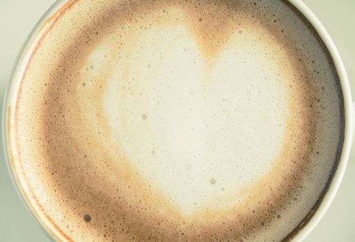 Vintage Flatlay Heart Shape Froth Milk Latte Art in White Coffee Cup Close Up on Black Wood Table. Heart shape froth milk Latte art hot beverage for coffee lover