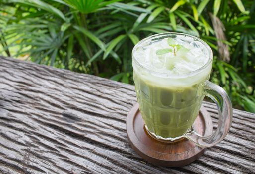 Cold Green Tea Milk Beverage or Cold Drinks Right Frame Crosswise View. Green cold drinks and ice on wood table for drink