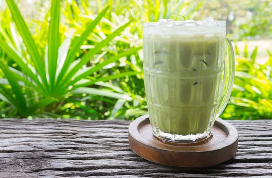 Cold Green Tea Milk Beverage or Cold Drinks Right Frame Side View. Green cold drinks and ice on wood table for drink