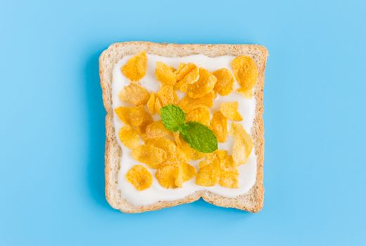 Cornflakes on Yogurt on Bread with Peppermint on Blue Pastel Background Flatlay Zoom. Cereal Breakfast bread healthy clean food for food and dessert category