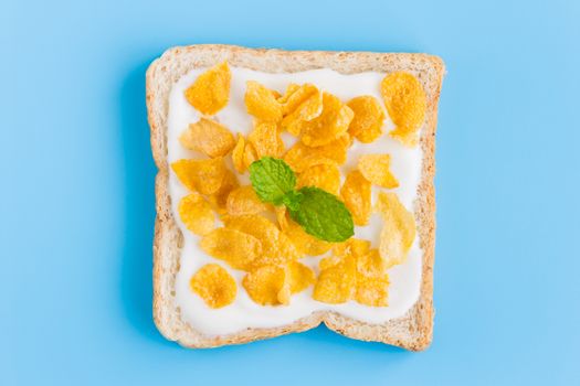 Cornflakes on Yogurt on Bread with Peppermint on Blue Pastel Background Flatlay Zoom. Cereal Breakfast bread healthy clean food for food and dessert category