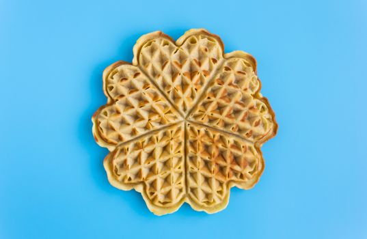 Full Piece Waffle on Blue Pastel Background Minimalist Style. No food color waffle on pastel background in dessert or food category