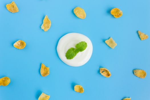 Peppermint on Yogurt with Cornflakes on Blue Pastel Background Minimalist Style. Cereal Breakfast healthy clean food for food and dessert category