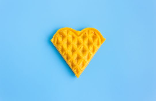 1 Piece Heart Shape Waffle on Blue Pastel Background Minimalist Style. Heart shape waffle dessert in minimalist style for food and dessert category