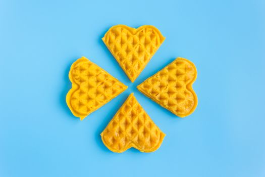 4 Pieces Waffle on Blue Pastel Background Minimalist Style. Heart shape waffle dessert in minimalist style for food and dessert category