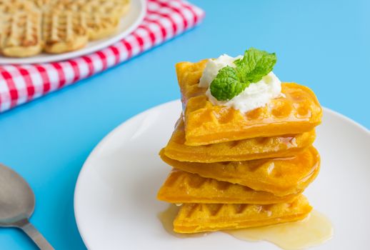 5 Pieces Heart Shape Waffle and Peppermint and Honey on Blue Pastel Background Right. Heart shape waffle dessert for food and dessert category