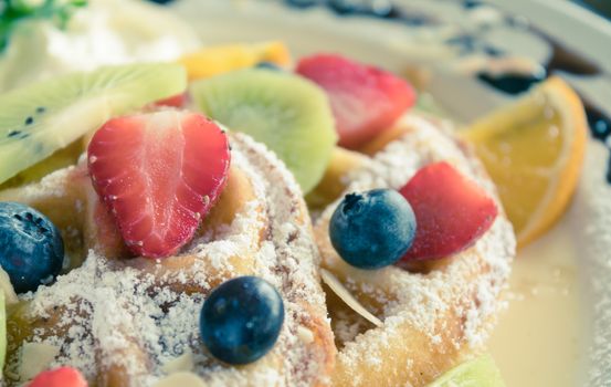 Vintage Strawberry Blueberry Kiwi Lemon Waffle Dessert Close Up. Fruity dessert food and drink category