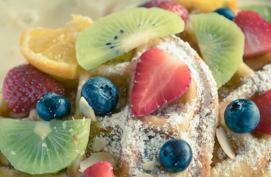 Vintage Strawberry Blueberry Kiwi Lemon Waffle Dessert Close Up. Fruity dessert food and drink category