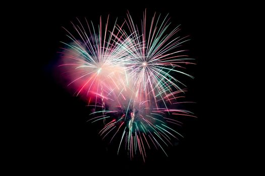 Red Green Sparkling Fireworks Background on Night Scene. Abstract color fireworks background and smoke on sky
