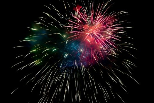 Red Green Blue Sparkling Fireworks Background on Night Scene. Abstract color fireworks background and smoke on sky