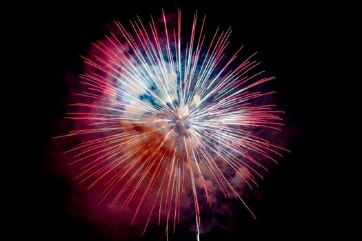 Red Orange Sparkling Fireworks Background on Night Scene. Abstract color fireworks background and smoke on sky