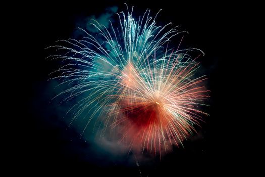 Blue Orange Sparkling Fireworks Background on Night Scene. Abstract color fireworks background and smoke on sky