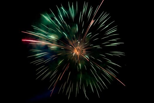 Center Green Orange Sparkling Fireworks Background on Night Scene. Abstract color fireworks background and smoke on sky