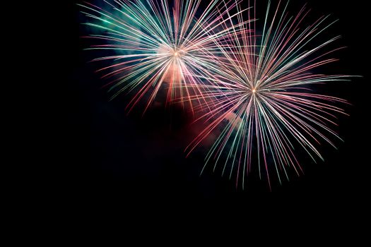 Green Red Sparkling Fireworks Background on Night Scene. Abstract color fireworks background and smoke on sky