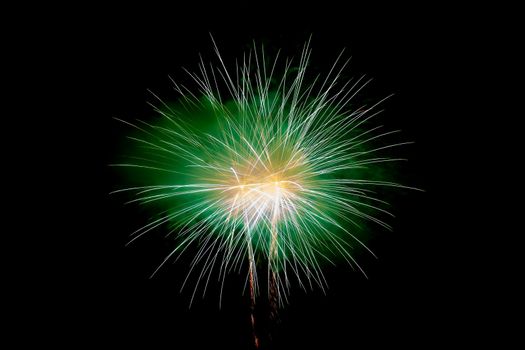 Green Yellow Sparkling Fireworks Background on Night Scene. Abstract color fireworks background and smoke on sky