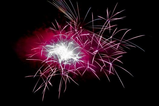 Magenta Horizontal Sparkling Fireworks Background on Night Scene. Abstract color fireworks background and smoke on sky