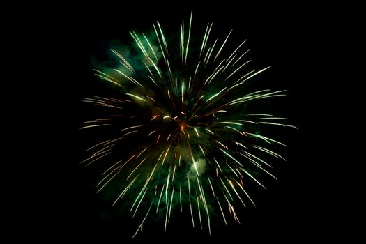 Orange Green Sparkling Fireworks Background on Night Scene. Abstract color fireworks background and smoke on sky