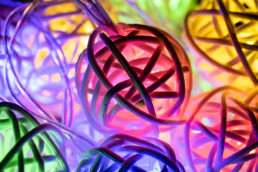 Colorful Christmas Lights String Background. Christmas Lights String in Rattan Ball Shape on Dark Scene.
