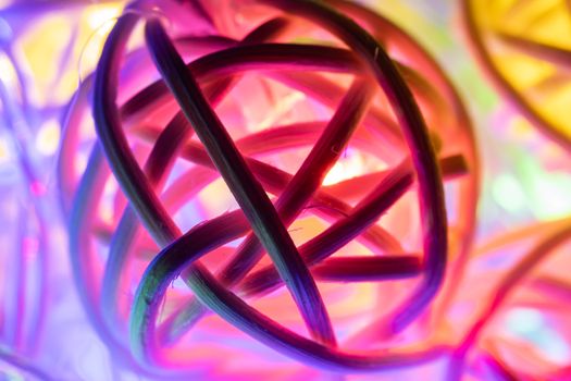 Red Purple Christmas Lights Rattan Ball Background in Close up View