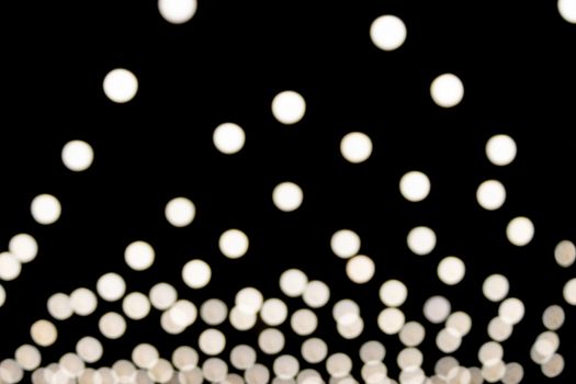 White Triangle Shape Blurred Lights on Black Background