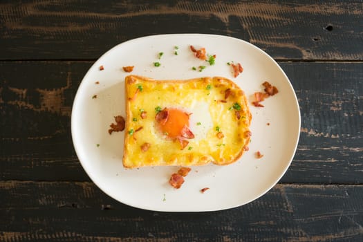 Egg Yolk Bacon Ham Cheese Toast and Coriander. Breakfast egg yolk bacon ham cheese with bread toast with coriander on top for food and drink category