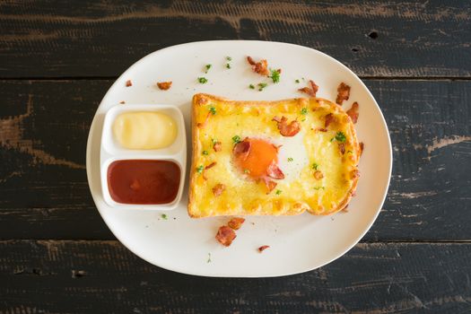 Egg Yolk Bacon Ham Cheese Toast and Coriander. Breakfast egg yolk bacon ham cheese with bread toast with coriander on top for food and drink category