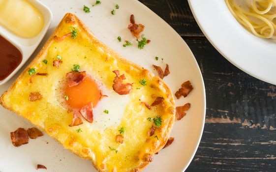 Egg Yolk Bacon Ham Cheese Toast and Coriander. Breakfast egg yolk bacon ham cheese with bread toast with coriander on top for food and drink category