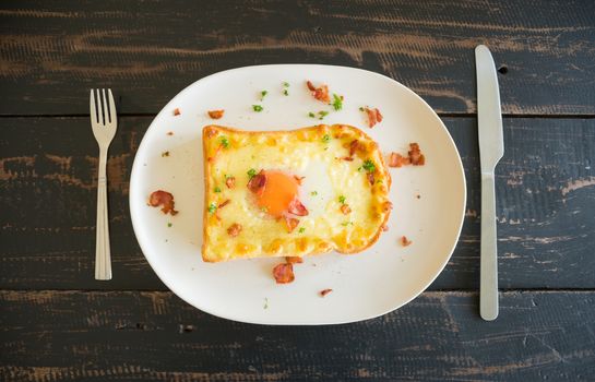 Egg Yolk Bacon Ham Cheese Toast and Coriander. Breakfast egg yolk bacon ham cheese with bread toast with coriander on top for food and drink category