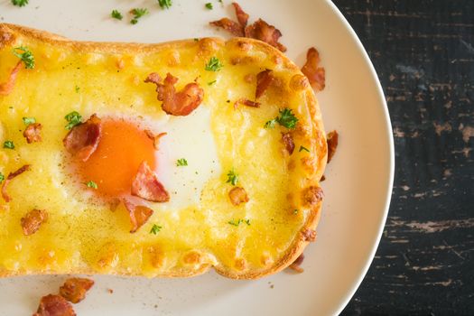 Egg Yolk Bacon Ham Cheese Toast and Coriander. Breakfast egg yolk bacon ham cheese with bread toast with coriander on top for food and drink category