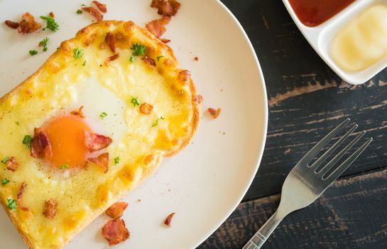 Egg Yolk Bacon Ham Cheese Toast and Coriander. Breakfast egg yolk bacon ham cheese with bread toast with coriander on top for food and drink category