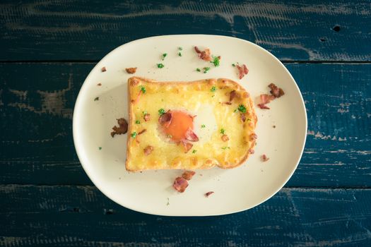 Egg Yolk Bacon Ham Cheese Toast and Coriander. Breakfast egg yolk bacon ham cheese with bread toast with coriander on top for food and drink category