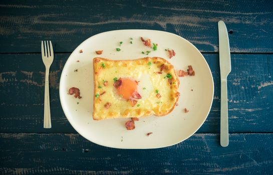 Egg Yolk Bacon Ham Cheese Toast and Coriander. Breakfast egg yolk bacon ham cheese with bread toast with coriander on top for food and drink category