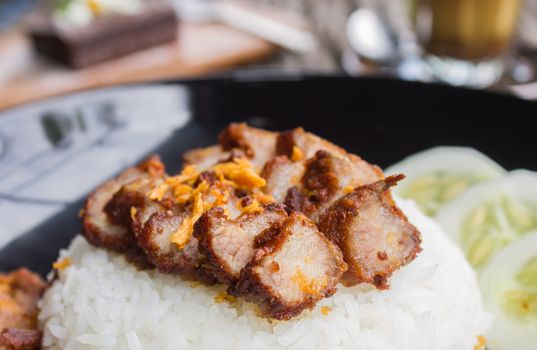 Thai Food Fried Pork with Garlic with Cucumber and Chocolate Brownie Cake and Latte Coffee. Fried pork with garlic steak on rice in food and drink category