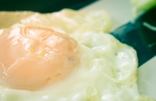 Fried Egg on Dish with Natural Light in Close Up View. Delicious Breakfast for Health in Vintage Tone