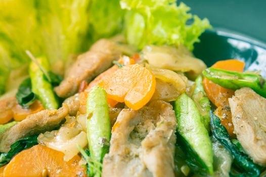 Stir Fried Noodle and Pork and Carrot and Yardlong Beans and Lettuce with Black Soy Sauce with Natural Light in Center Frame in Vintage Tone