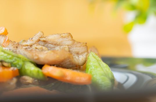 Stir Fried Noodle and Pork and Carrot and Yardlong Beans and Lettuce with Black Soy Sauce with Natural Light on Left Frame on Tree Background