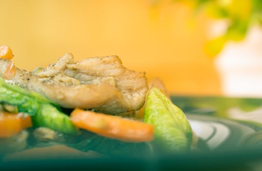 Stir Fried Noodle and Pork and Carrot and Yardlong Beans and Lettuce with Black Soy Sauce with Natural Light on Left Frame on Tree Background in Vintage Tone