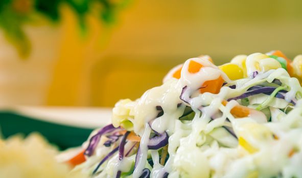 Vegan Salad with Mayonnaise Topping in Close Up View include Carrot and Tomato and Corn and Cabbage and Peas and Lettuce on Right Frame in Vintage Tone