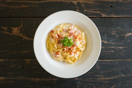 Spaghetti Carbonara with Bacon and Ham and Parsley and Mayonnaise Sauce. Spaghetti Carbonara with Bacon and Ham in mayonnaise cream sauce for food and drink category. 
Spaghetti Carbonara with Bacon breakfast